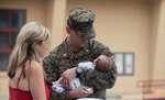 Service member holds newborn child