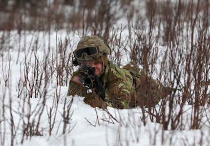 Alaska Army National Guard Spc. Megan Koszarek with Avalanche Company, 1-297th Infantry Battalion, participates in squad and platoon situational training exercises (STX) at Alcantra armory in Wasilla, Alaska, March 11, 2022. An STX is a short, scenario-driven, mission-oriented exercise designed to train one collective task or a group of related tasks or battle drills. For the A-Co. Soldiers, the STX allows for evaluation of basic Soldier skills and leadership competencies to determine proficiency and certify the platoon to conduct live-fire exercises. It also reinforces previous training that the Soldiers have completed by bringing the entire platoon together to further prepare the unit for live-fire training. The infantrymen are preparing to participate in the Army National Guard’s eXportable Combat Training Capability (XCTC) program, which is a brigade field training exercise similar to a Combat Training Center. They will participate in an XCTC rotation at Camp Roberts, California, July 2022. (U.S. Army National Guard photo by Spc. Grace Nechanicky)