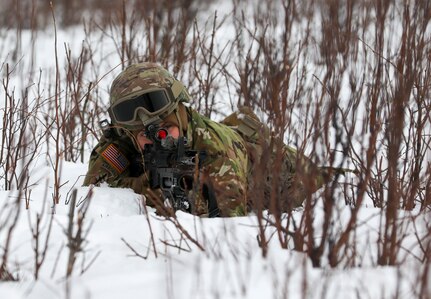 Alaska Army National Guard Spc. Megan Koszarek with Avalanche Company, 1-297th Infantry Battalion, participates in squad and platoon situational training exercises (STX) at Alcantra armory in Wasilla, Alaska, March 11, 2022. An STX is a short, scenario-driven, mission-oriented exercise designed to train one collective task or a group of related tasks or battle drills. For the A-Co. Soldiers, the STX allows for evaluation of basic Soldier skills and leadership competencies to determine proficiency and certify the platoon to conduct live-fire exercises. It also reinforces previous training that the Soldiers have completed by bringing the entire platoon together to further prepare the unit for live-fire training. The infantrymen are preparing to participate in the Army National Guard’s eXportable Combat Training Capability (XCTC) program, which is a brigade field training exercise similar to a Combat Training Center. They will participate in an XCTC rotation at Camp Roberts, California, July 2022. (U.S. Army National Guard photo by Spc. Grace Nechanicky)