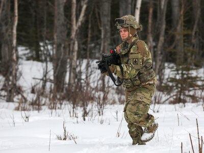 Alaska Army National Guard Spc. Megan Koszarek with Avalanche Company, 1-297th Infantry Battalion, participates in squad and platoon situational training exercises (STX) at Alcantra armory in Wasilla, Alaska, March 11, 2022. An STX is a short, scenario-driven, mission-oriented exercise designed to train one collective task or a group of related tasks or battle drills. For the A-Co. Soldiers, the STX allows for evaluation of basic Soldier skills and leadership competencies to determine proficiency and certify the platoon to conduct live-fire exercises. It also reinforces previous training that the Soldiers have completed by bringing the entire platoon together to further prepare the unit for live-fire training. The infantrymen are preparing to participate in the Army National Guard’s eXportable Combat Training Capability (XCTC) program, which is a brigade field training exercise similar to a Combat Training Center. They will participate in an XCTC rotation at Camp Roberts, California, July 2022. (U.S. Army National Guard photo by Spc. Grace Nechanicky)