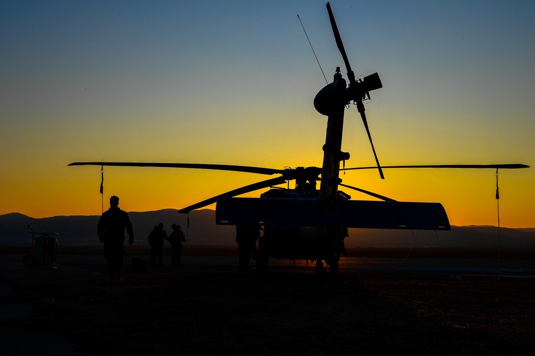 Troop works on a helicopter.