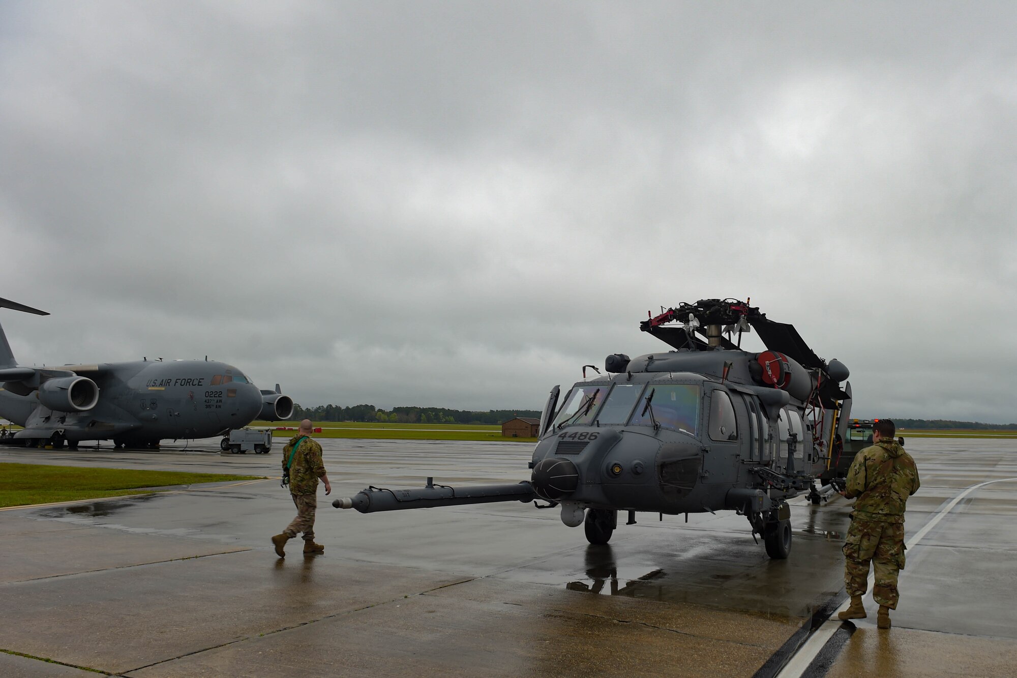 A photo of Airmen guiding a helicopter.