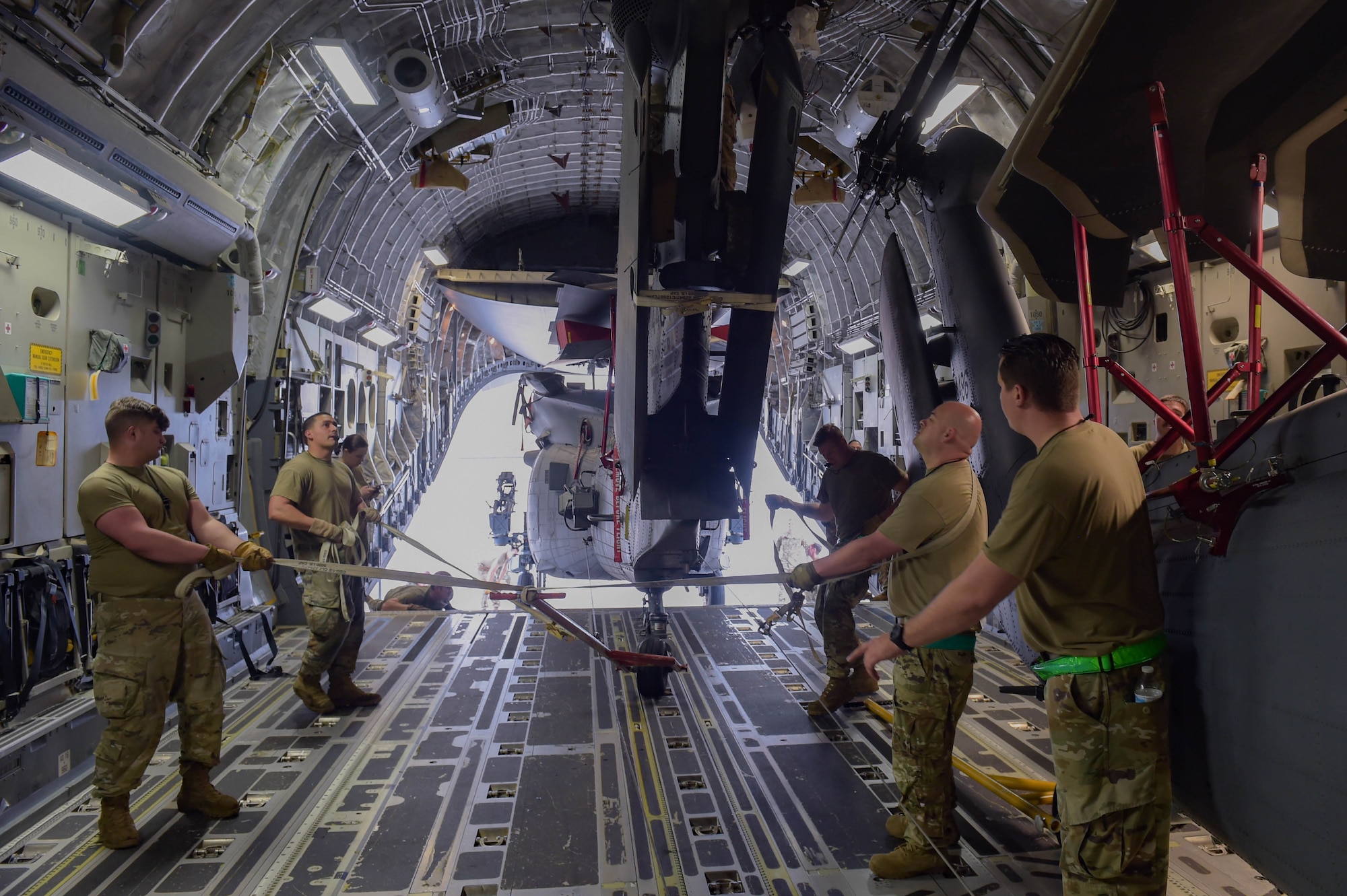 A photo of Airmen pulling an aircraft.