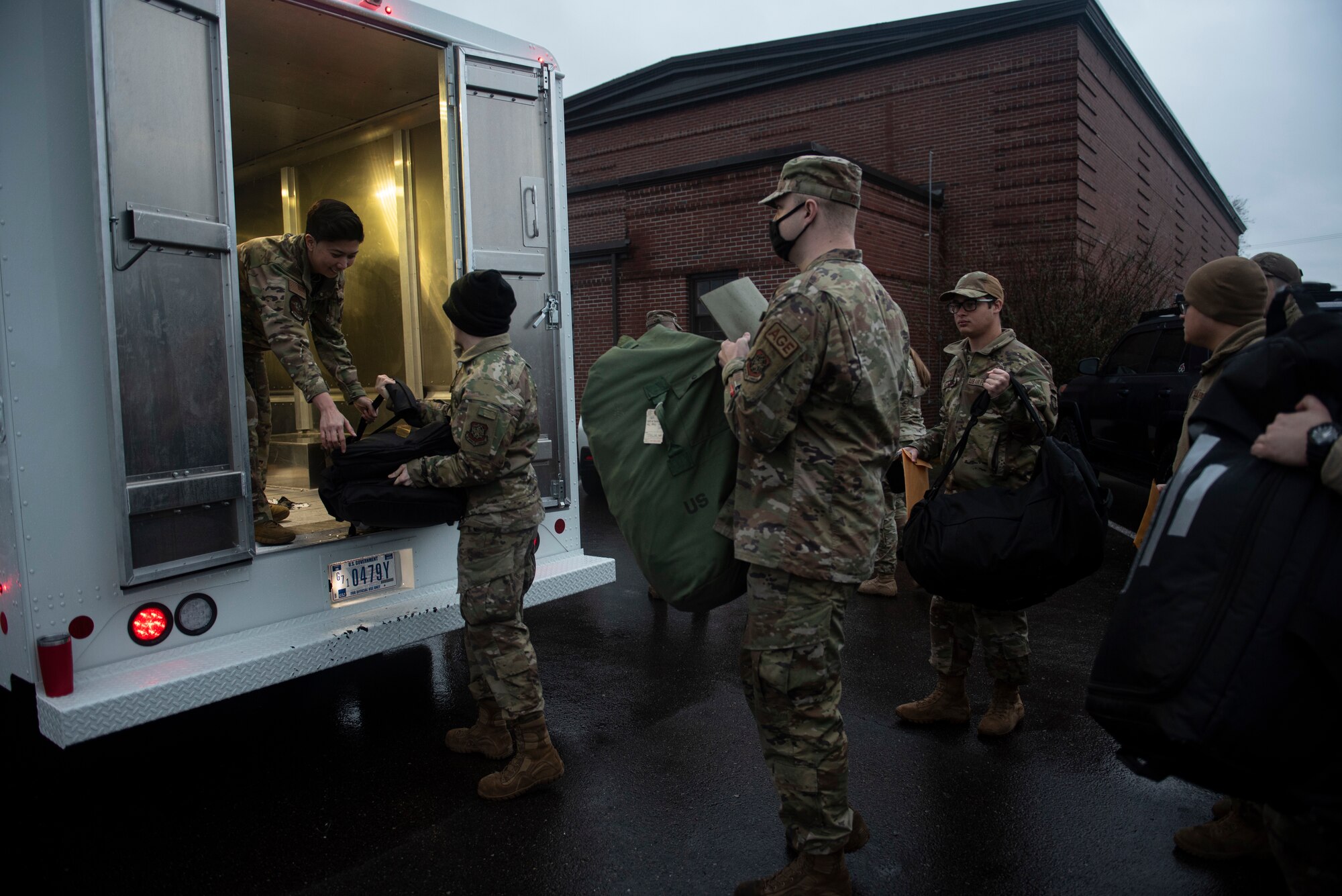 U.S. Air Force Airmen load their personal bags into a truck in preparation for Exercise Rainier War 22A at Joint Base Lewis-McChord, Washington, March 15, 2022. Rainier War 22A exercised and evaluated the wing’s ability to employ the force and its  ability to perform during wartime and/or contingency taskings in a high-intensity, wartime contested, degraded and operationally limited environment while supporting the contingency operations against a near-peer adversary. (U.S. Air Force photo by Master Sgt. Julius Delos Reyes)