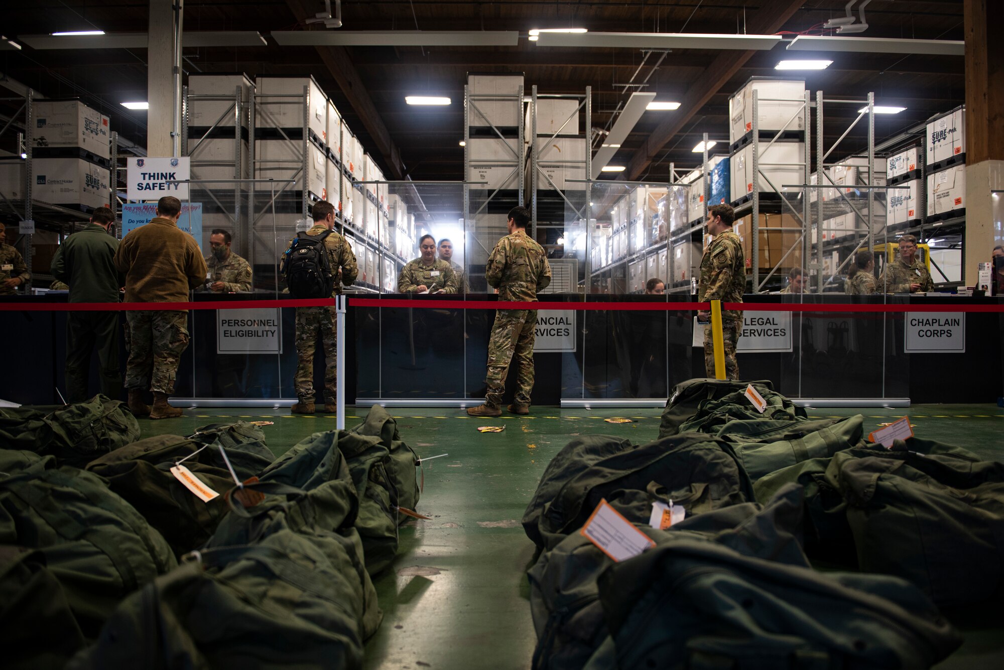 U.S. Air Force Airmen process through the deployment line as part of Exercise Rainier War 22A at Joint Base Lewis-McChord, Washington, March 15, 2022. Rainier War 22A exercised and evaluated the wing’s ability to employ the force and its  ability to perform during wartime and/or contingency taskings in a high-intensity, wartime contested, degraded and operationally limited environment while supporting the contingency operations against a near-peer adversary. (U.S. Air Force photo by Master Sgt. Julius Delos Reyes)