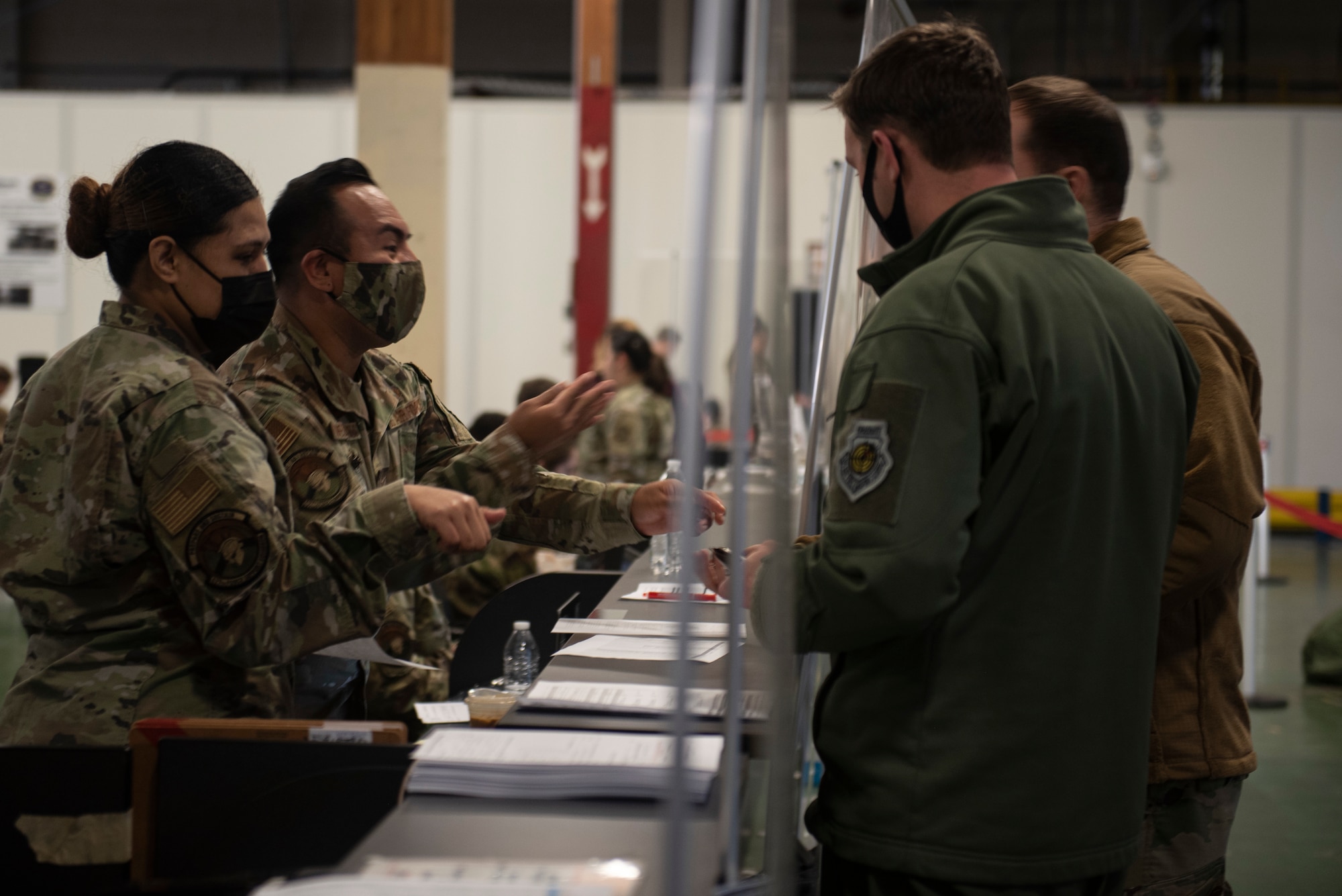 U.S. Air Force Airmen process through the deployment line as part of Exercise Rainier War 22A at Joint Base Lewis-McChord, Washington, March 15, 2022. Rainier War 22A exercised and evaluated the wing’s ability to employ the force and its  ability to perform during wartime and/or contingency taskings in a high-intensity, wartime contested, degraded and operationally limited environment while supporting the contingency operations against a near-peer adversary. (U.S. Air Force photo by Master Sgt. Julius Delos Reyes)