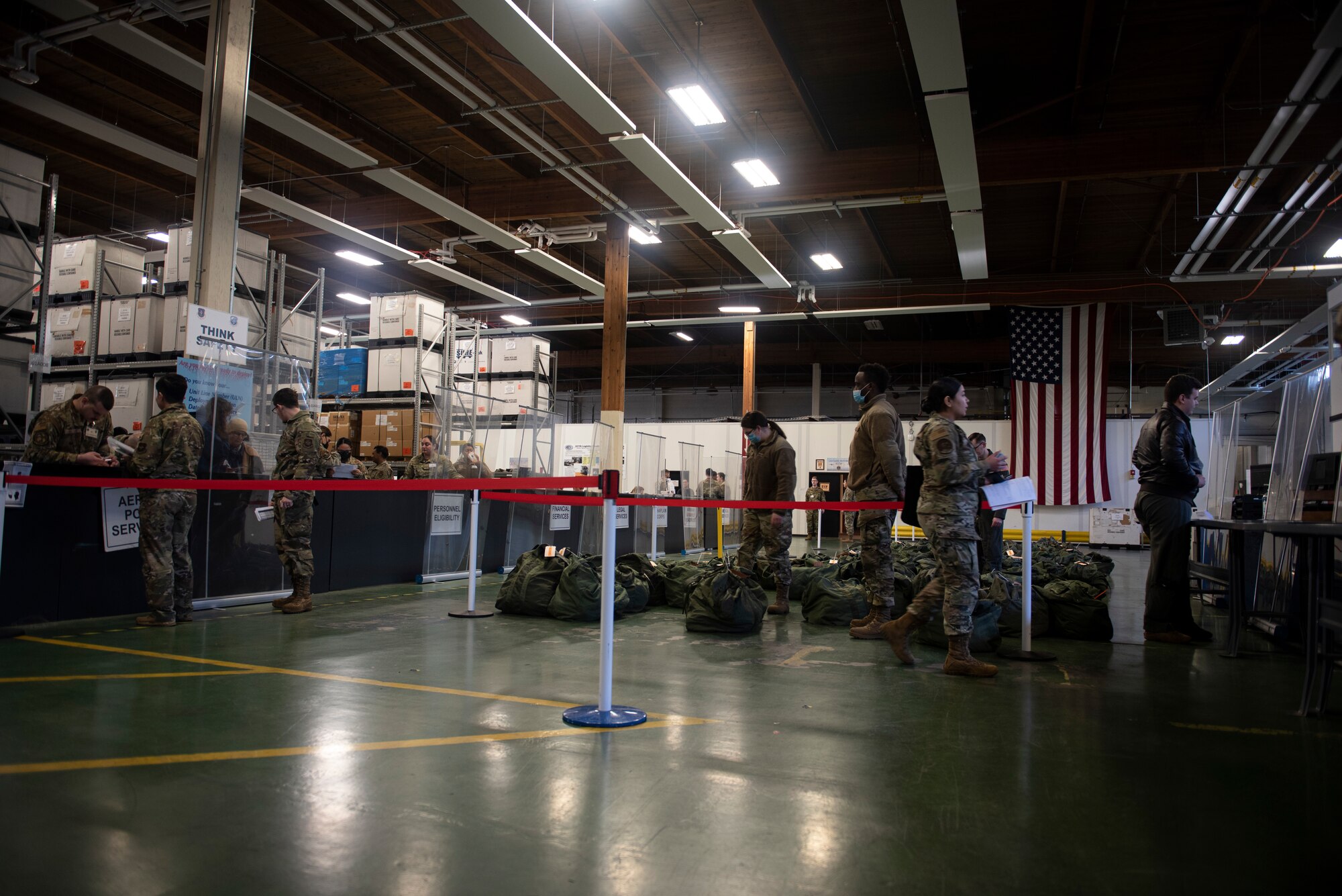 U.S. Air Force Airmen process through the deployment line as part of Exercise Rainier War 22A at Joint Base Lewis-McChord, Washington, March 15, 2022. Rainier War 22A exercised and evaluated the wing’s ability to employ the force and its  ability to perform during wartime and/or contingency taskings in a high-intensity, wartime contested, degraded and operationally limited environment while supporting the contingency operations against a near-peer adversary. (U.S. Air Force photo by Master Sgt. Julius Delos Reyes)