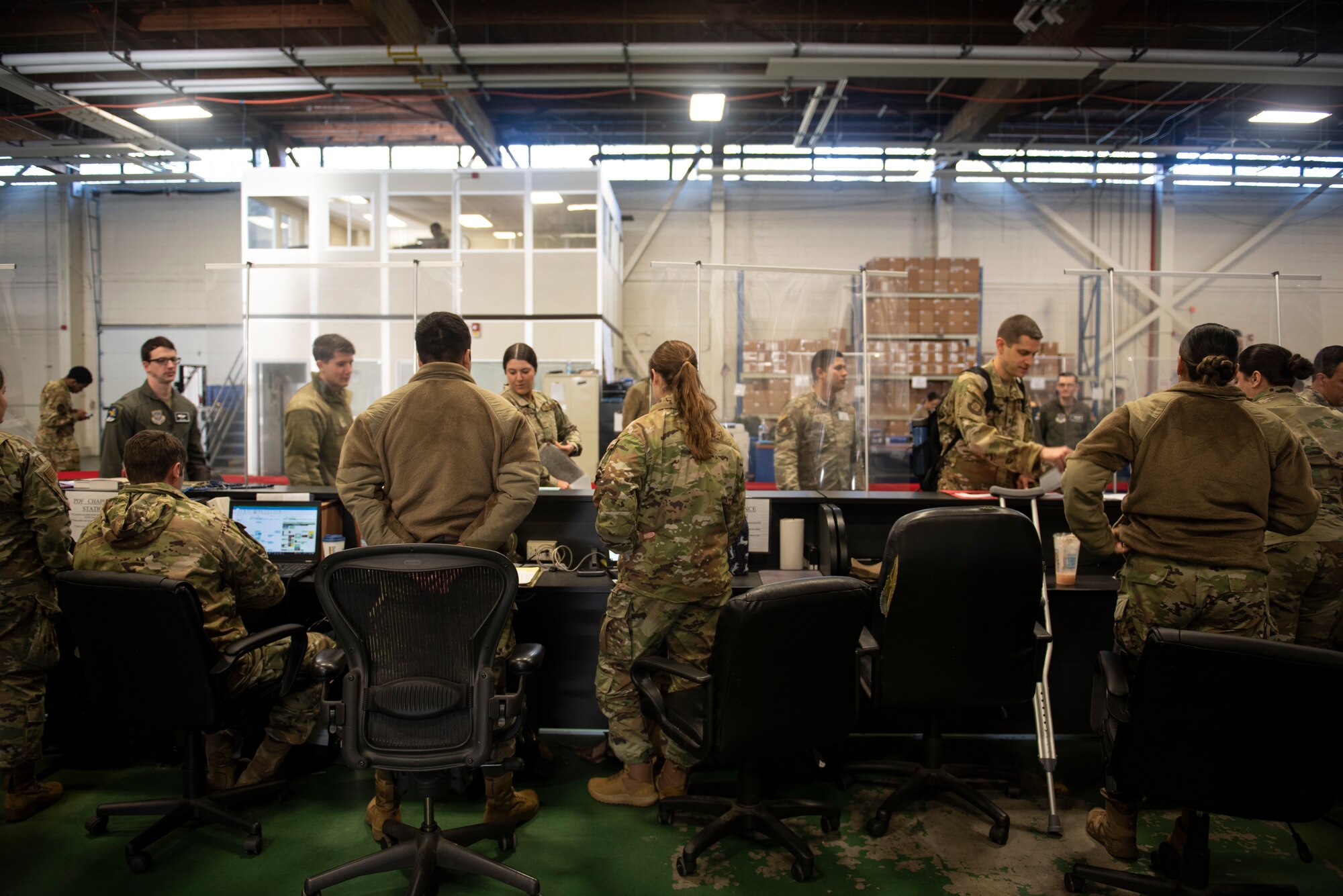 U.S. Air Force Airmen process through the deployment line as part of Exercise Rainier War 22A at Joint Base Lewis-McChord, Washington, March 15, 2022. Rainier War 22A exercised and evaluated the wing’s ability to employ the force and its  ability to perform during wartime and/or contingency taskings in a high-intensity, wartime contested, degraded and operationally limited environment while supporting the contingency operations against a near-peer adversary. (U.S. Air Force photo by Master Sgt. Julius Delos Reyes)