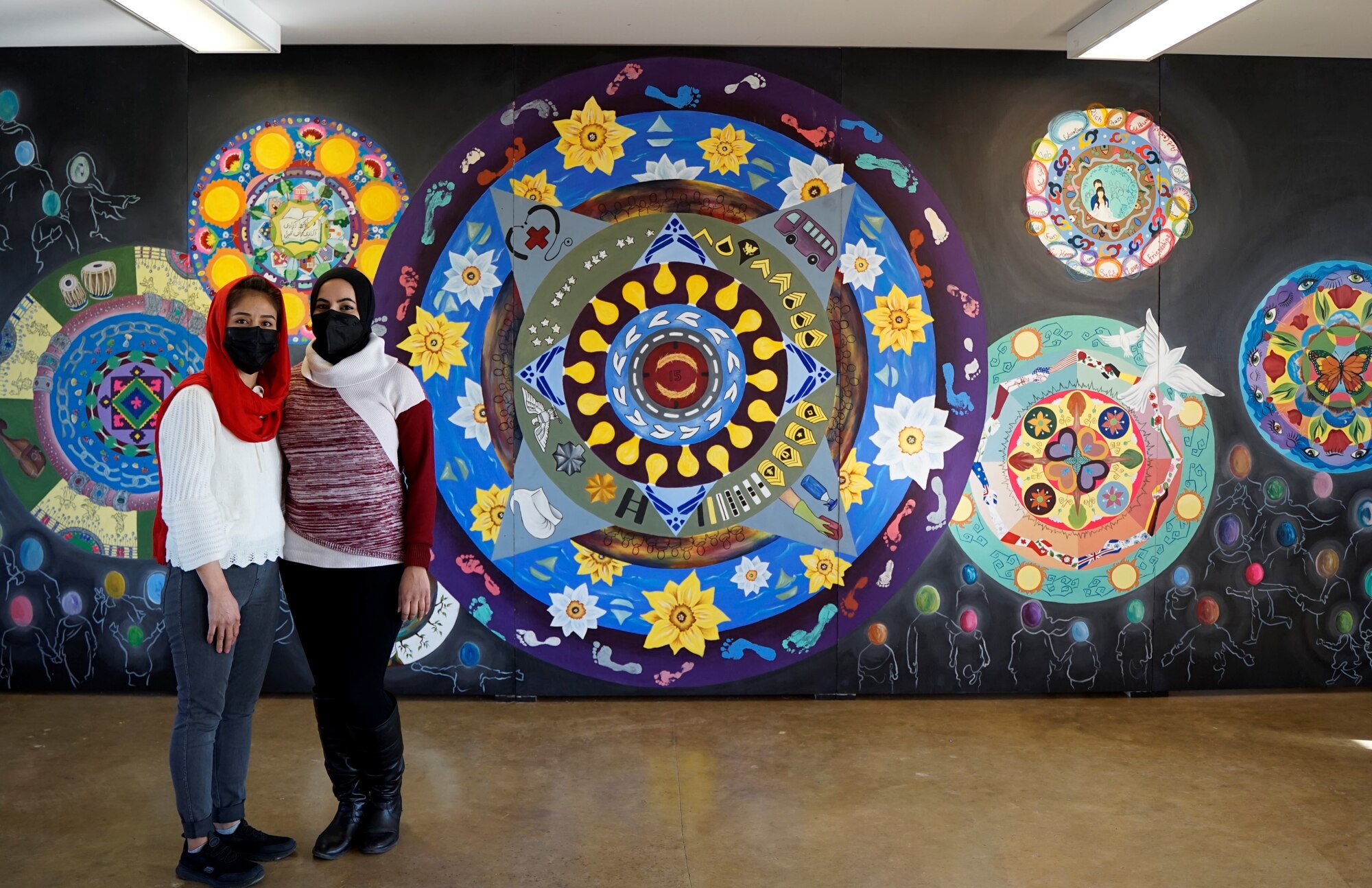 Afghan guests show off their completed “traveling mural” to Soldiers and leaders of Operation Allies Welcome at Camp Atterbury, Ind., Dec. 21, 2021. The project, inspired by the artists’ experiences in Afghanistan and hopes for a better future, incorporates therapeutic techniques and creative expression as a means to promote healing and well-being among Afghan evacuees during the resettlement process. This initiative provides essential support at secure locations outside of Afghanistan. The Department of Defense, through U.S. Northern Command, and in support of the Department of Homeland Security, is providing transportation, temporary housing, medical screening, and general support for at least 50,000 Afghan evacuees at suitable facilities in permanent or temporary structures as quickly as possible. (U.S. Army video by Sgt. Trinity Carter/ 14th Public Affairs Detachment)