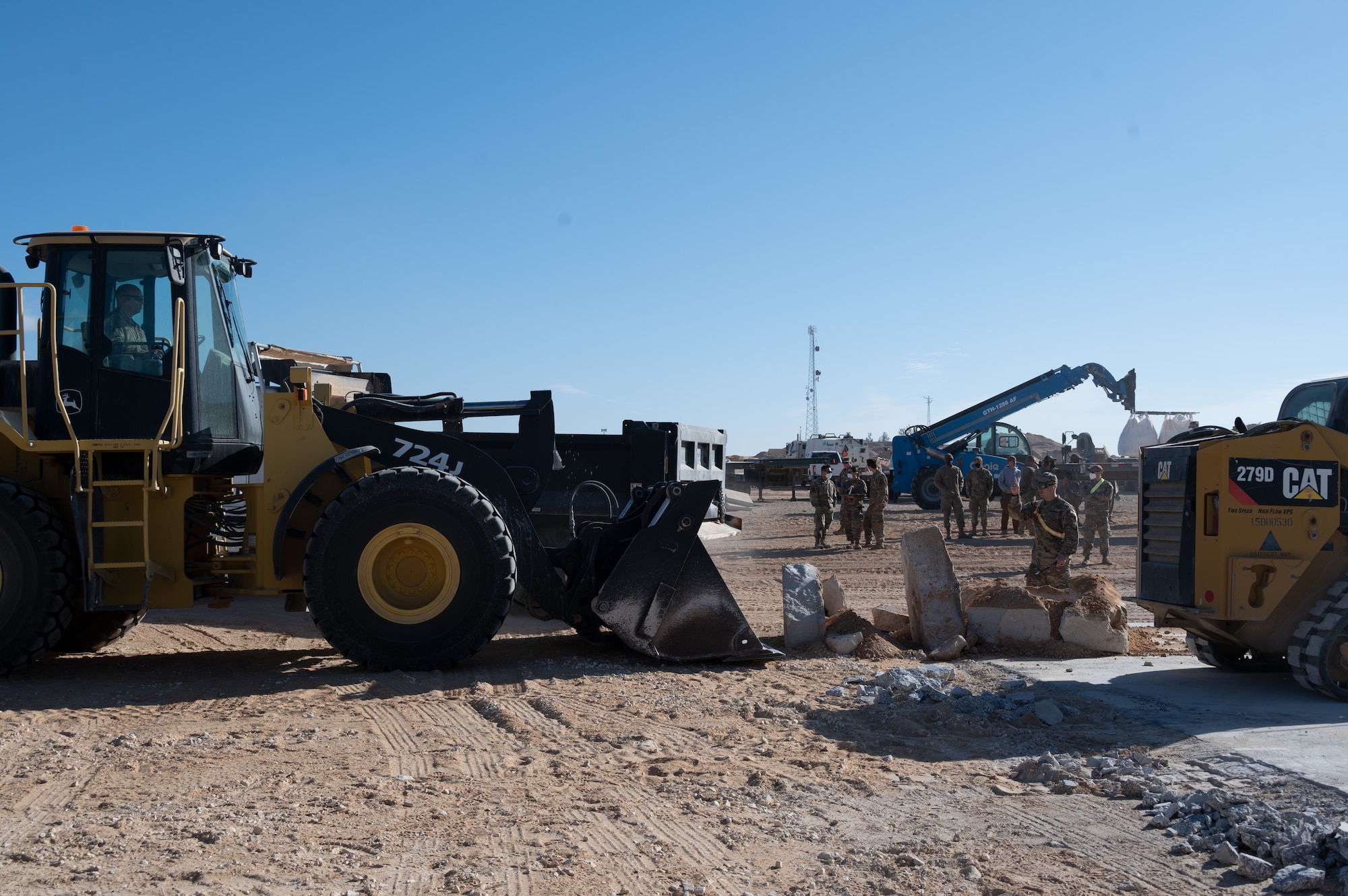 332d Expeditionary Civil Engineer Squadron Airmen use heavy equipment to move simulated broken runway during a Rapid Airfield Damage Recovery (RADR) exercise at an undisclosed location in Southwest Asia, Feb. 10, 2022. This exercise tested the ability of the 332d ECES to rapidly repair runways and runway support structures to recover and resume airfield operations after it has experienced significant damage. The 332d ECES provides, operates, and maintains a sustainable installation through engineering and emergency response services across the full mission spectrum. (U.S Air Force photo by Tech. Sgt. Lauren M. Snyder)
