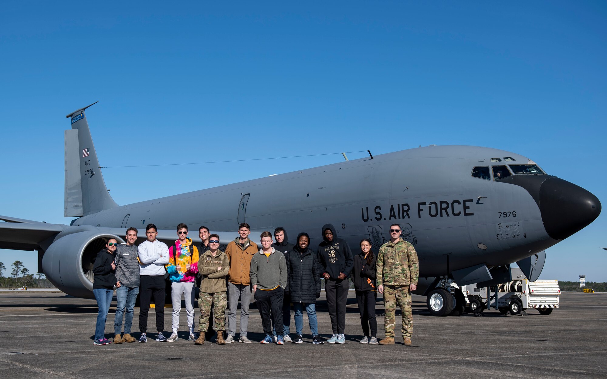 A group of Florida State University ROTC cadets and U.S. Air Force 1st Lt. Tim Reed, a pilot assigned to the 91st Air Refueling Squadron, pose for a photo near a KC-135 Stratotanker assigned to MacDill Air Force Base, Florida, at Naval Air Station Pensacola, Florida, March 12, 2022. The students flew in the MacDill aircraft as part of an orientation flight to strengthen relations and bolster community support. (U.S. Air Force photo by Airman 1st Class Lauren Cobin)