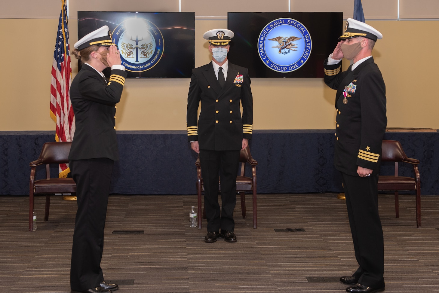 Cmdr. Blythe Blakistone, left, relieves Cmdr. David West, right, as commanding officer of Naval Special Warfare Tactical Communications Command (TCC) 1 during a change of command ceremony at Naval Base Coronado.