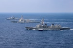 SOUTH CHINA SEA (March 15, 2022) The guided-missile destroyer USS Momsen (DDG 92), Royal Australian Navy Anzac-class frigate HMAS Arunta (FFH 151), and Japan Maritime Self-Defense Force Murasame-class guided missile destroyer JS Yuudachi (DD 103) transit the South China Sea during a trilateral training event. Momsen is assigned to Commander, Task Force 71/Destroyer Squadron (DESRON) 15, the Navy's largest forward-deployed DESRON and the U.S. 7th Fleet's principal fighting force, and is underway supporting a free and open Indo-Pacific. (U.S. Navy photo by Naval Air Crewman (Helicopter) 1st Class Justin Sherman)