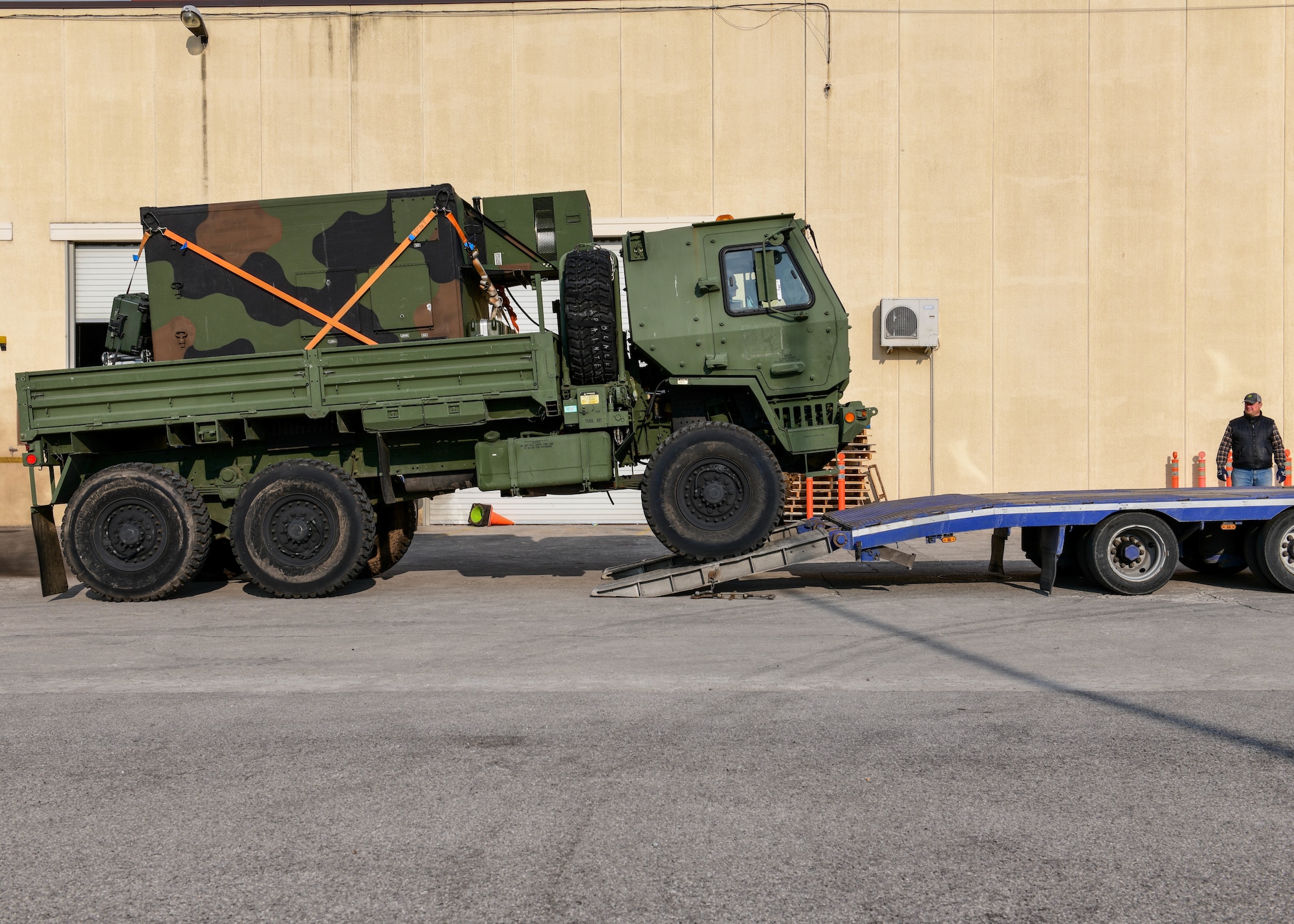 A five-ton truck is loaded onto a trailer at Aviano Air Base, Italy, March 4, 2022. The 31st Logistics Readiness Squadron Traffic Management section sent cargo such as trucks, medical supplies, computer equipment, mobility bags and more to deployed members in Eastern Europe. (U.S. Air Force photo by Senior Airman Brooke Moeder)