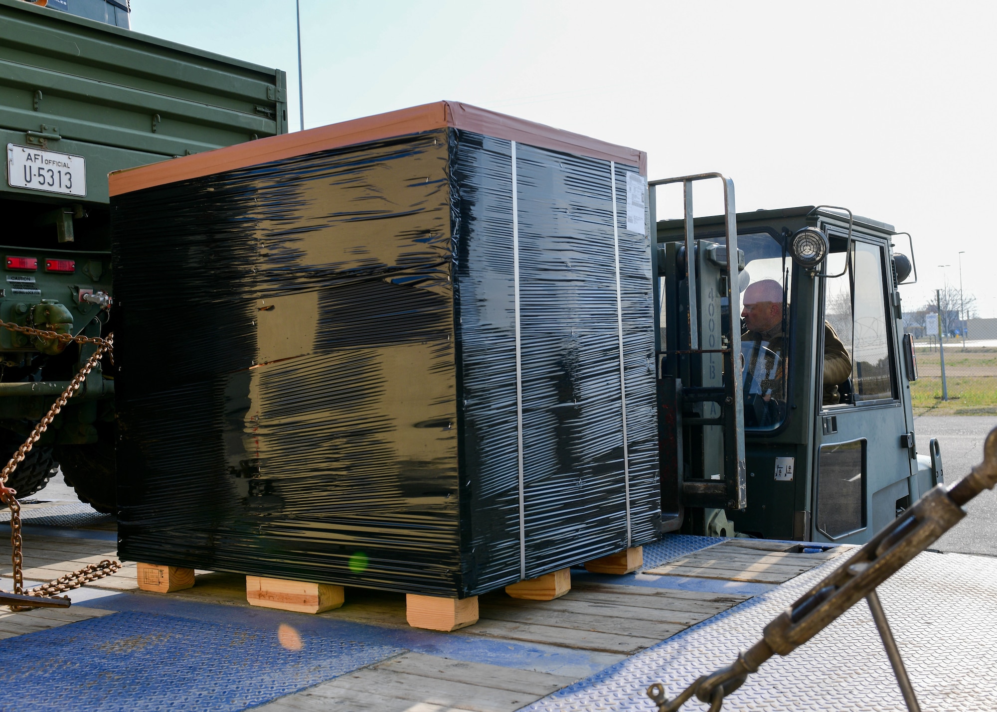 A cargo pallet is loaded onto a trailer at Aviano Air Base, Italy, March 4, 2022. The cargo pallet contained mobility bags and medical supplies and was shipped to deployed 31st Fighter Wing Airmen in Eastern Europe. (U.S. Air Force photo by Senior Airman Brooke Moeder)