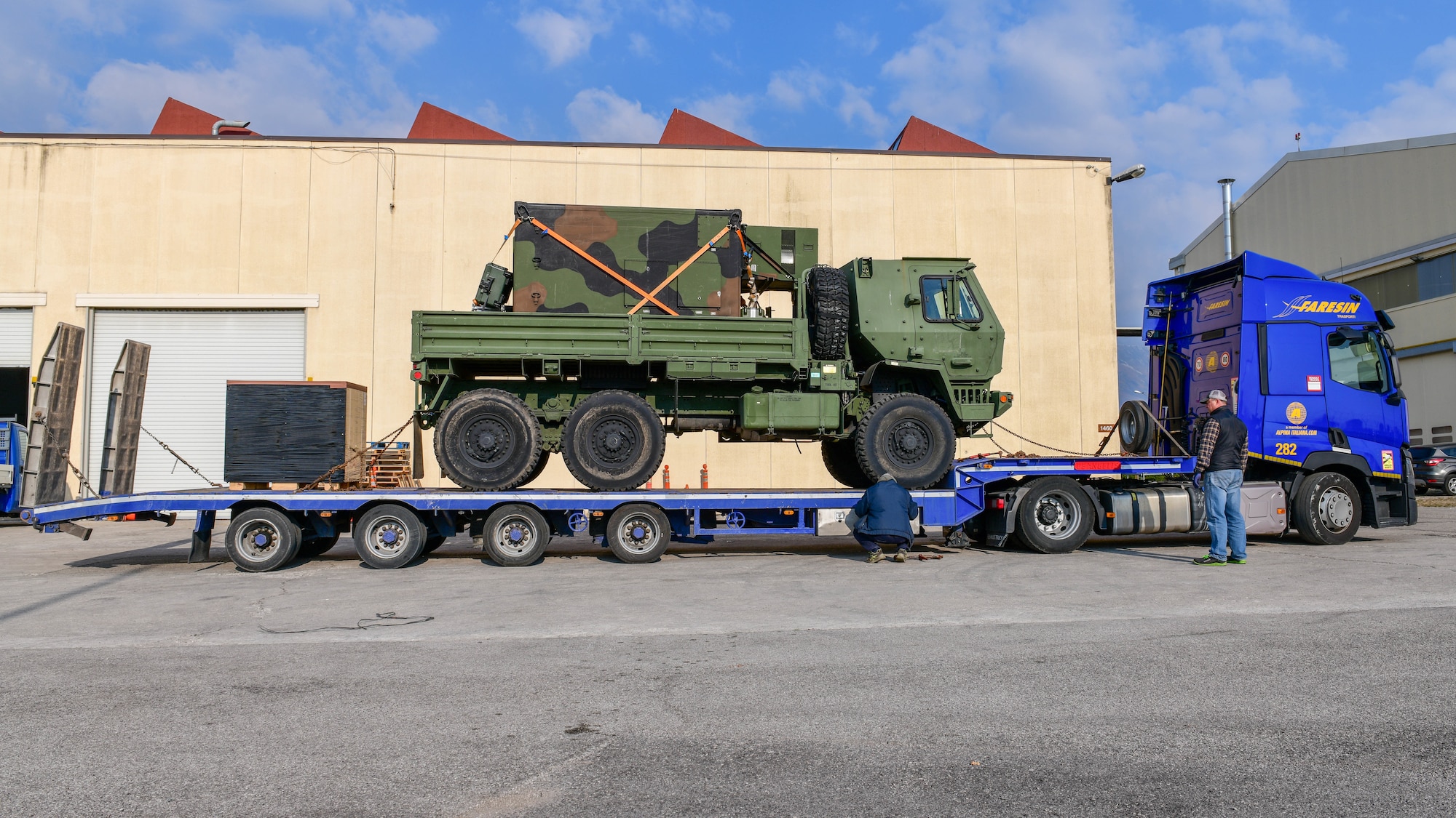 A five-ton truck and cargo pallet are loaded onto a trailer to be shipped to 31st Fighter Wing Airmen deployed to eastern Europe at Aviano Air Base, Italy, March 4, 2022. The cargo pallet contained mobility bags and medical supplies and was shipped to deployed 31st Fighter Wing Airmen in Eastern Europe. (U.S. Air Force photo by Senior Airman Brooke Moeder)