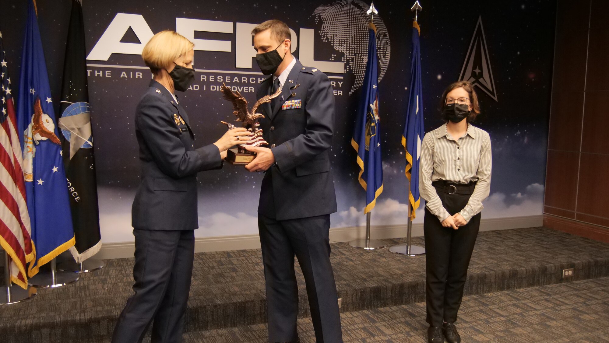 Maj. Gen. Heather Pringle, AFRL commander, presents the Richard Neal Special Recognition Award for a Senior Individual to Judson McCarty, of the AFRL Systems Technology Office, March 1, 2022 at the AFRL Annual Awards Ceremony at Wright-Patterson Air Force Base, Ohio. Accepting the award on behalf of Mr. McCarty is Lt. Col. Nathaniel Liefer. Abby Neal, daughter of Richard Neal, looks on. (U.S. Air Force photo/Keith Lewis)