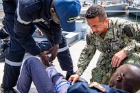 Cmdr. Javier Agraz speaks to a patient at a clinic set up for Exercise Obangame Express located at the Senegalese Naval Headquarters, in Dakar, Senegal, Mar. 14, 2022.