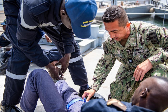Cmdr. Javier Agraz speaks to a patient at a clinic set up for Exercise Obangame Express located at the Senegalese Naval Headquarters, in Dakar, Senegal, Mar. 14, 2022.