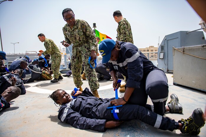 U.S. Sailors observe Senegalese sailors during a medical training onboard the Senegalese Navy's patrol ship, Fouladou, as part of the Exercise Obangame Express in Dakar, Senegal, Mar. 14, 2022.