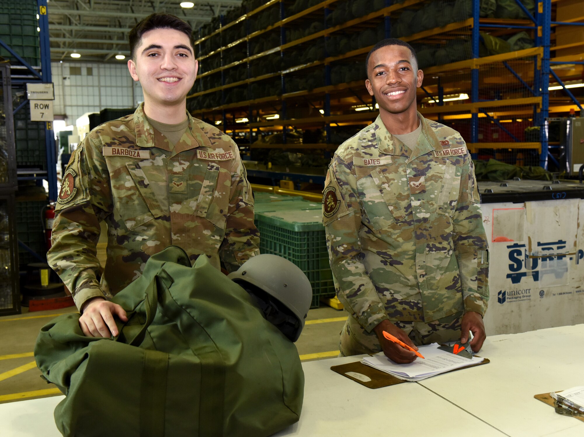 U.S. Air Force Airman 1st Class Christian Barboza, left, and Airman 1st Class Demetrius Bates, both 100th Logistics Readiness Squadron Individual Protective Equipment apprentices, check a training “Class C” chemical bag ready to issue to a customer at Royal Air Force Mildenhall, England, March 15, 2022. Airmen in the IPE shop support geographically separated units including RAF Croughton, and Stavanger, Norway, and issue all gear for chemical warfare assets to members tasked for deployments and TDYs, ensuring they are issued the correct equipment. (U.S. Air Force photo by Karen Abeyasekere)
