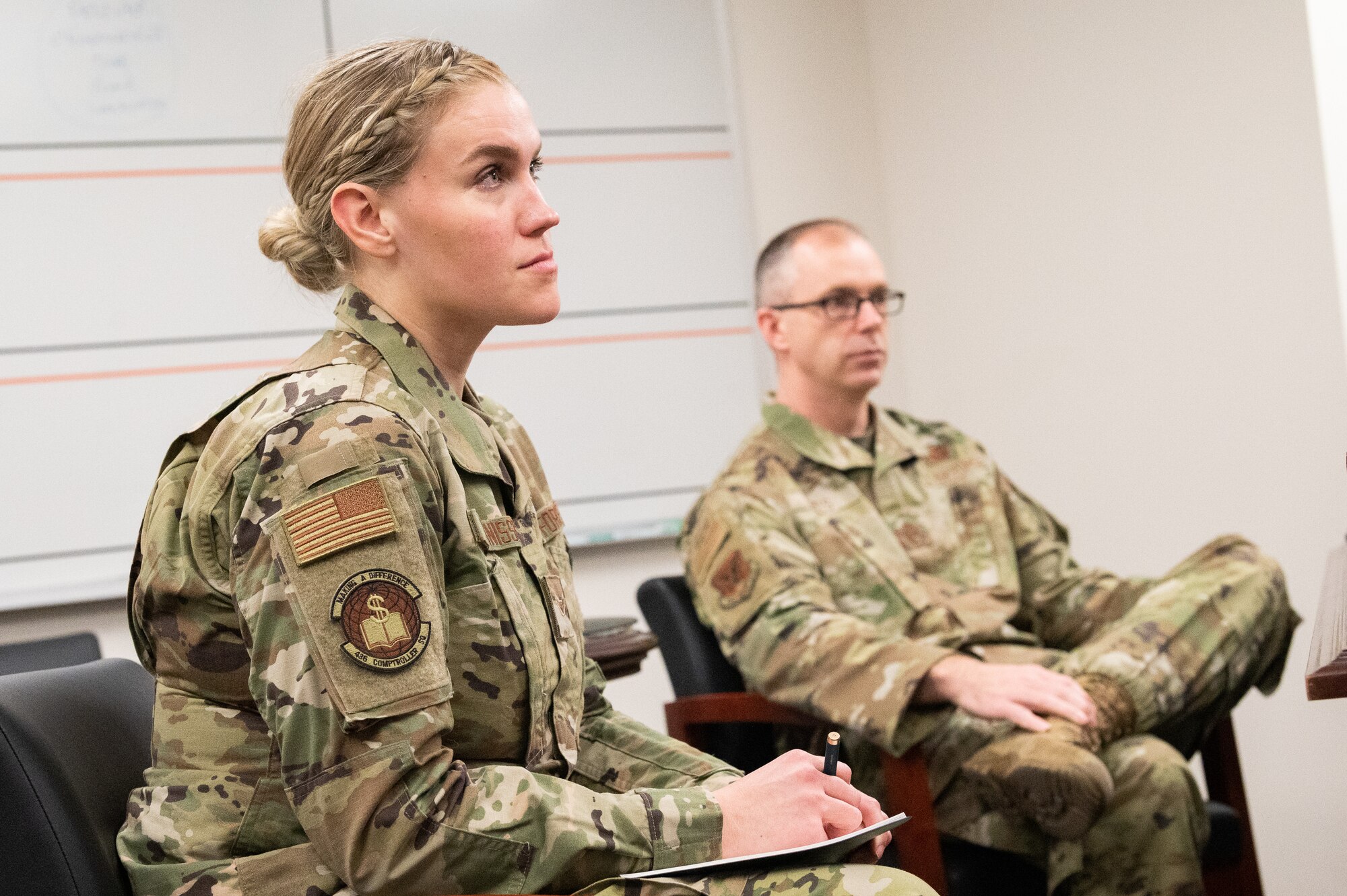 Chief Master Sgt. Timothy Bayes, left, 436th Airlift Wing command chief, discusses office mementoes with Airman 1st Class Shayna Teunissen, 436th Comptroller Squadron budget analyst, at Dover Air Force Base, Delaware, March 16, 2022. Teunissen accompanied Bayes as part of the Chief for the Day mentoring program, which offers Airmen a first-hand experience of the command chief’s typical work day. (U.S. Air Force photo by Mauricio Campino)