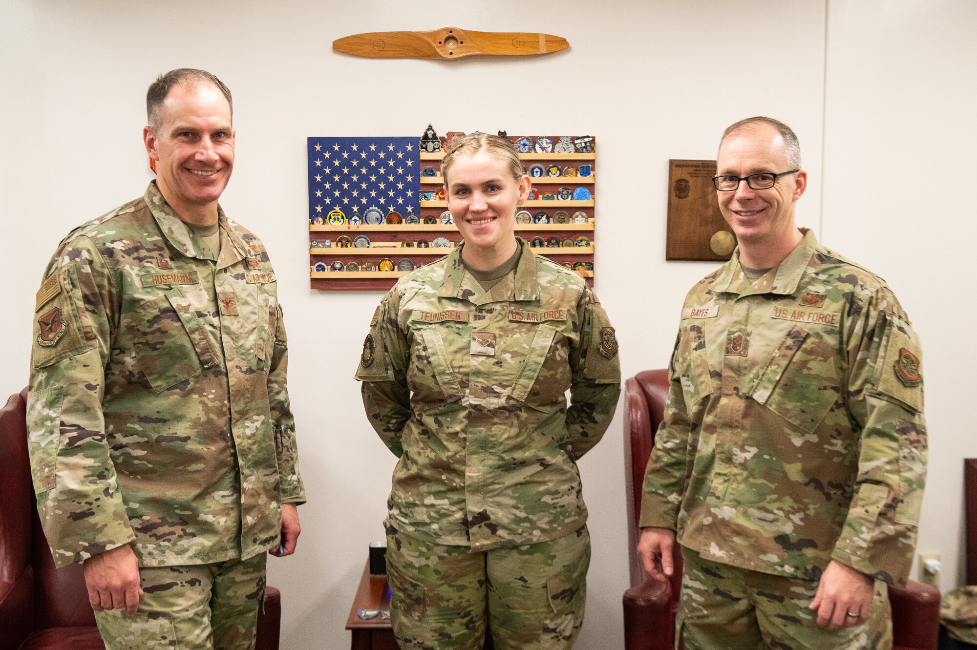 Col. Matt Husemann, left, 436th Airlift Wing commander, and Chief Master Sgt. Timothy Bayes, right, 436th AW command chief, stand with Airman 1st Class Shayna Teunissen, 436th Comptroller squadron budget analyst, at Dover Air Force Base, Delaware, March 16, 2022. Teunissen accompanied Bayes as part of the Chief for the Day mentoring program, which offers Airmen a first-hand experience of the command chief’s typical work day. (U.S. Air Force photo by Mauricio Campino)