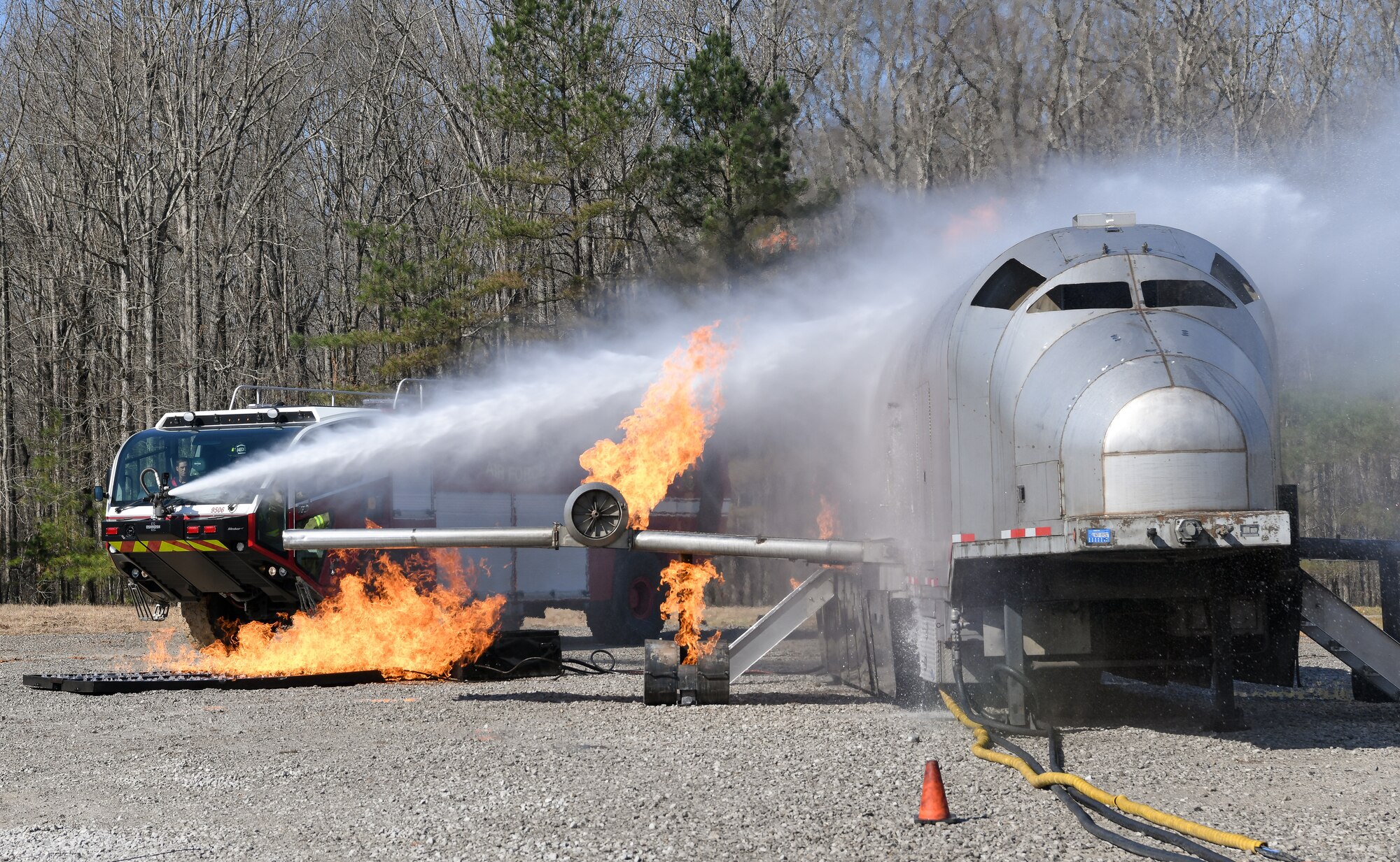 Water being sprayed from bumper turret onto aircraft fire simulator