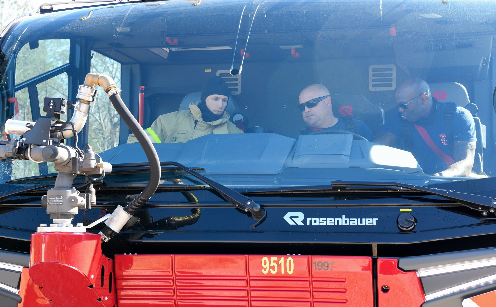 Jason Armstrong and Col. Chris Lance seen through windshield of firefighting vehicle
