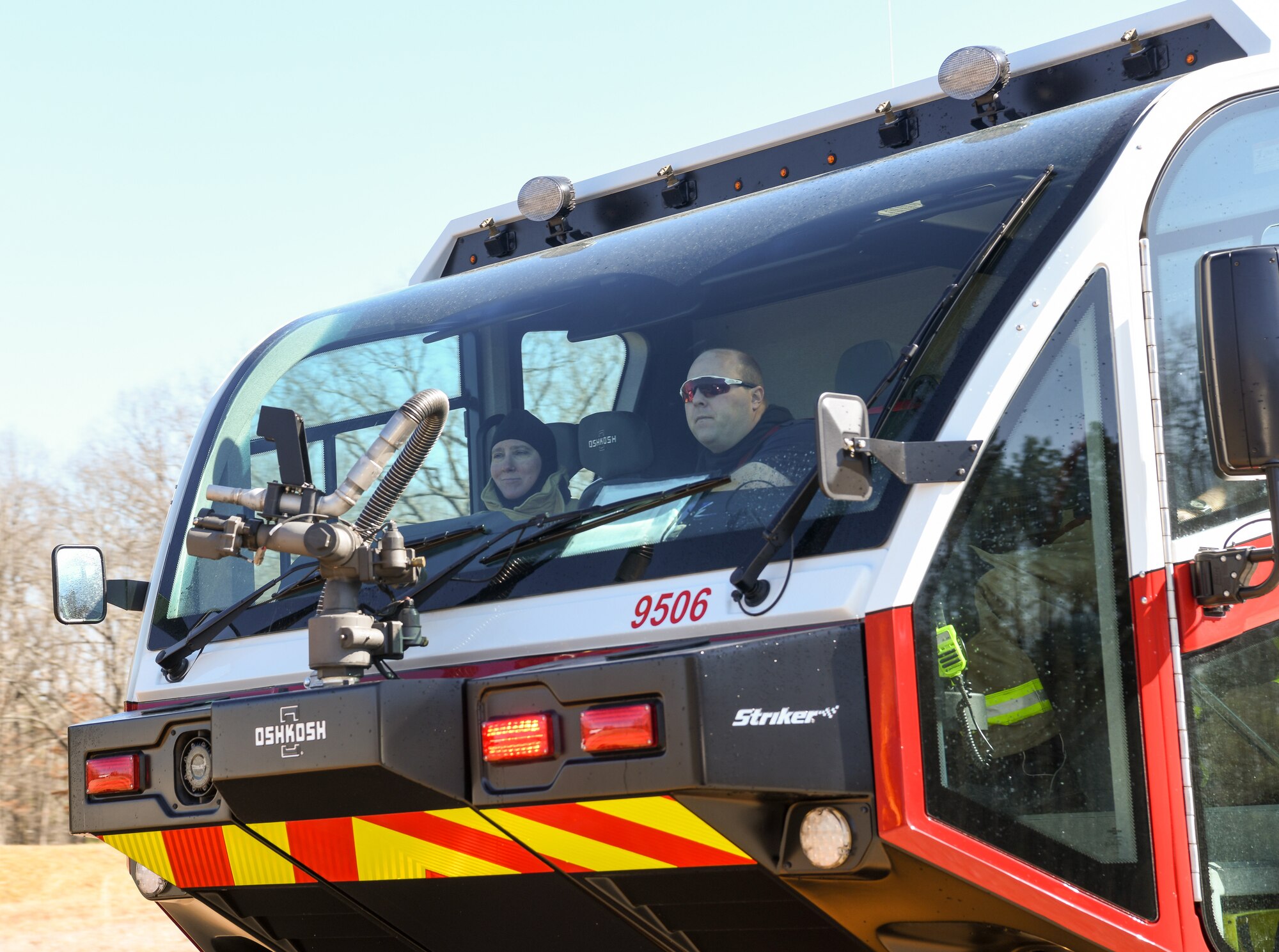 Whit Ross and Chief Master Sgt. Cirricione seen through windshield of firefighting vehicle