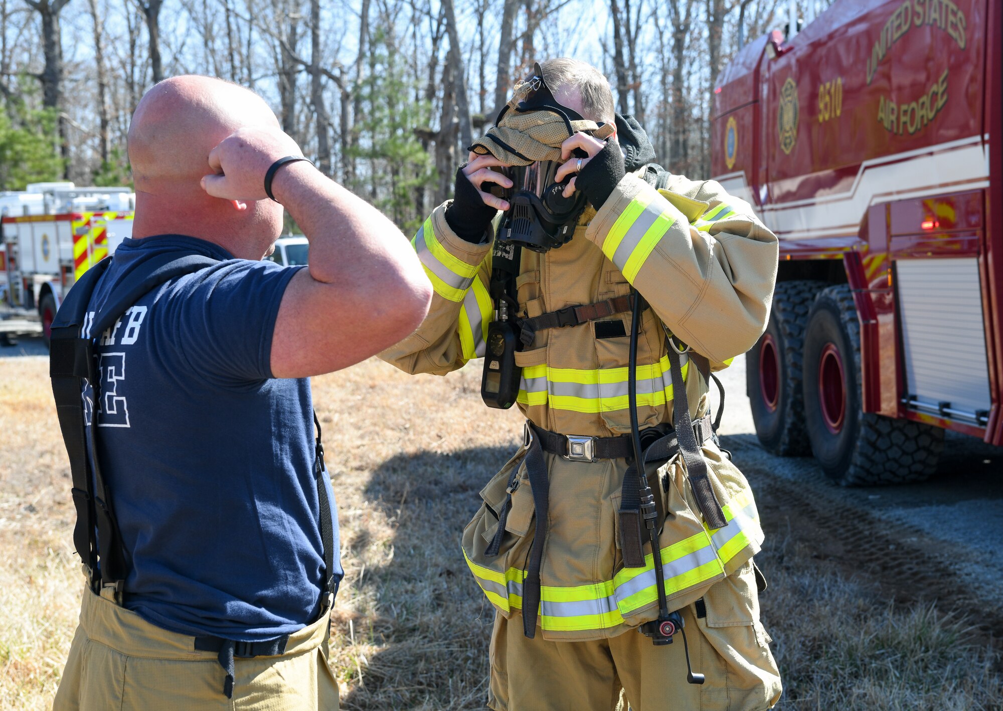 Jason Armstrong indicating how to put on mask to Col. Chris Lance