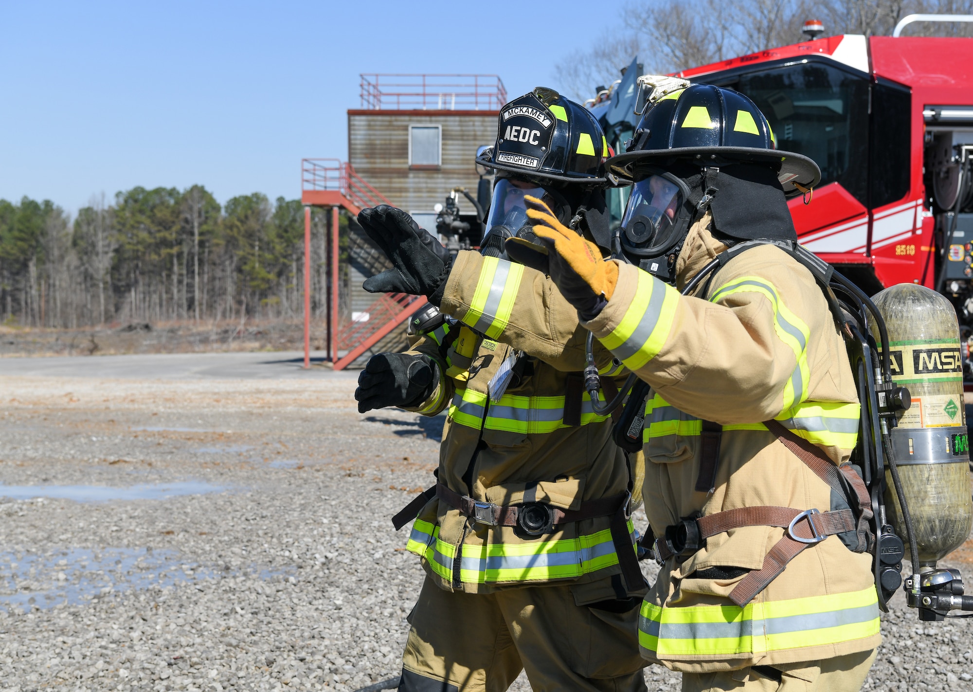 Adam McKamey and Chief Master Sgt. Jennifer Cirricione in firefighter gear