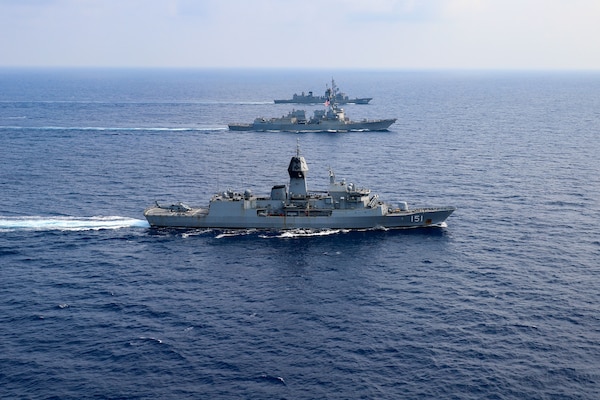 SOUTH CHINA SEA (March 15, 2022) The guided-missile destroyer USS Momsen (DDG 92), Royal Australian Navy Anzac-class frigate HMAS Arunta (FFH 151), and Japan Maritime Self-Defense Force Murasame-class guided missile destroyer JS Yuudachi (DD 103) transit the South China Sea during a trilateral training event. Momsen is assigned to Commander, Task Force 71/Destroyer Squadron (DESRON) 15, the Navy's largest forward-deployed DESRON and the U.S. 7th Fleet's principal fighting force, and is underway supporting a free and open Indo-Pacific. (U.S. Navy photo by Naval Air Crewman (Helicopter) 1st Class Justin Sherman)