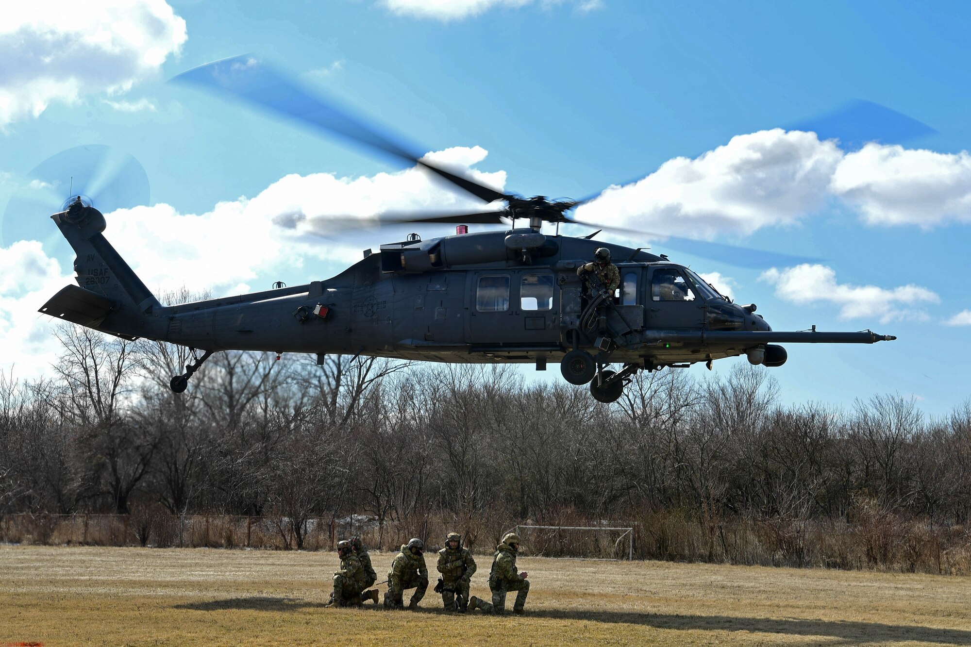 The 51st Commando Battalion Romanian Special Forces offload an HH-60G Pave Hawk assigned to the 56th Rescue Squadron in Romania, March 9, 2022. The 57th RQS and the 56th RQS alongside the Royal Marines Commando Mobile Air Operations team with Commando Helicopter Force provided training on how to safely operate around a helicopter to the 51st Commando Battalion Romanian Special Forces. (U.S. Air Force Photo by Senior Airman Noah Sudolcan)