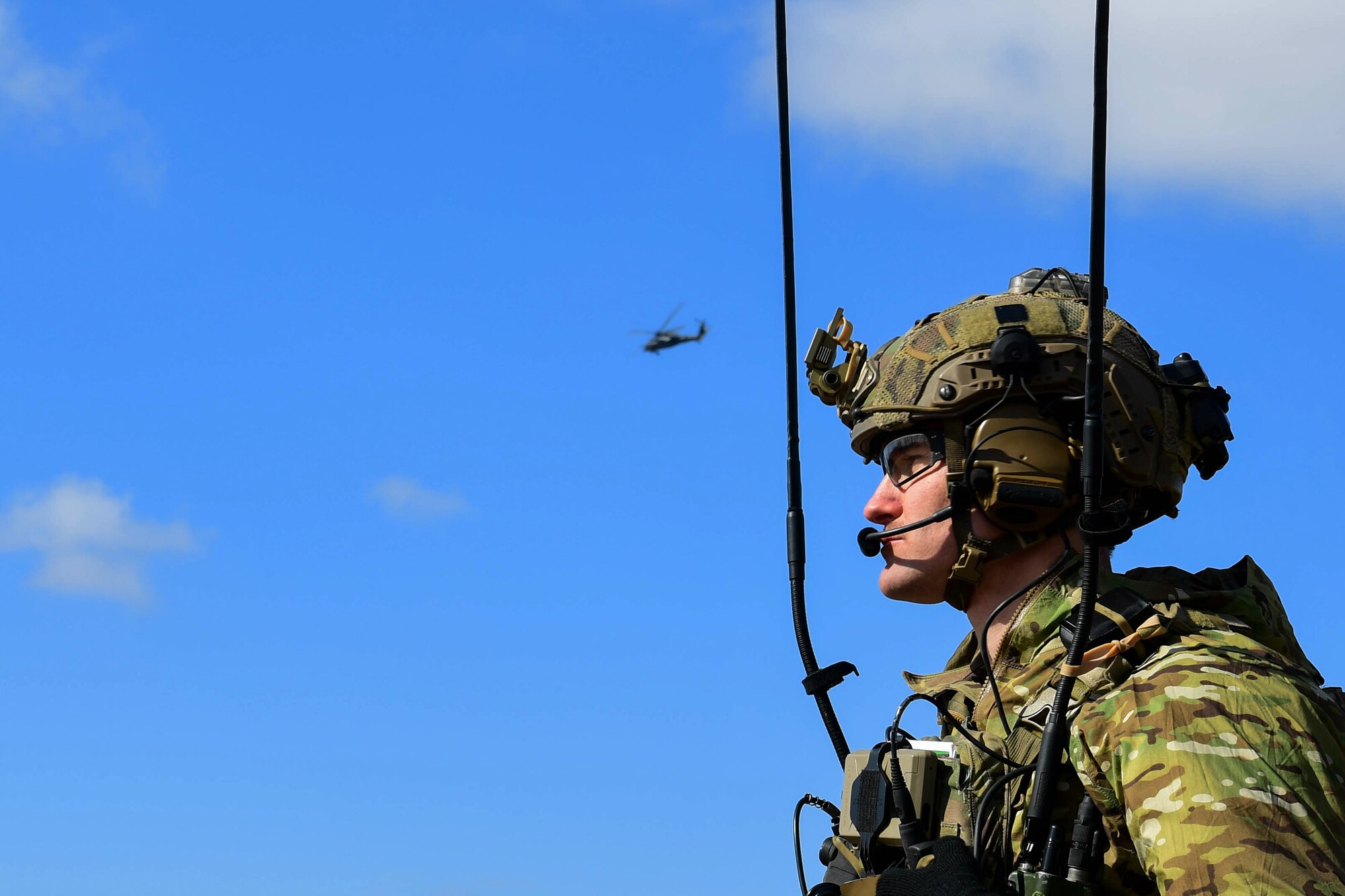 U.S. Air Force 1st Lt. Alexander Mount, 57th Rescue Squadron combat rescue officer, waits for an HH-60G Pave Hawk assigned to the 56th RQS to land in Romania, March 9, 2022. The 57th RQS and the 56th RQS alongside the Royal Marines Commando Mobile Air Operations team with Commando Helicopter Force provided training on how to safely operate around a helicopter to the 51st Commando Battalion Romanian Special Forces. (U.S. Air Force Photo by Senior Airman Noah Sudolcan)