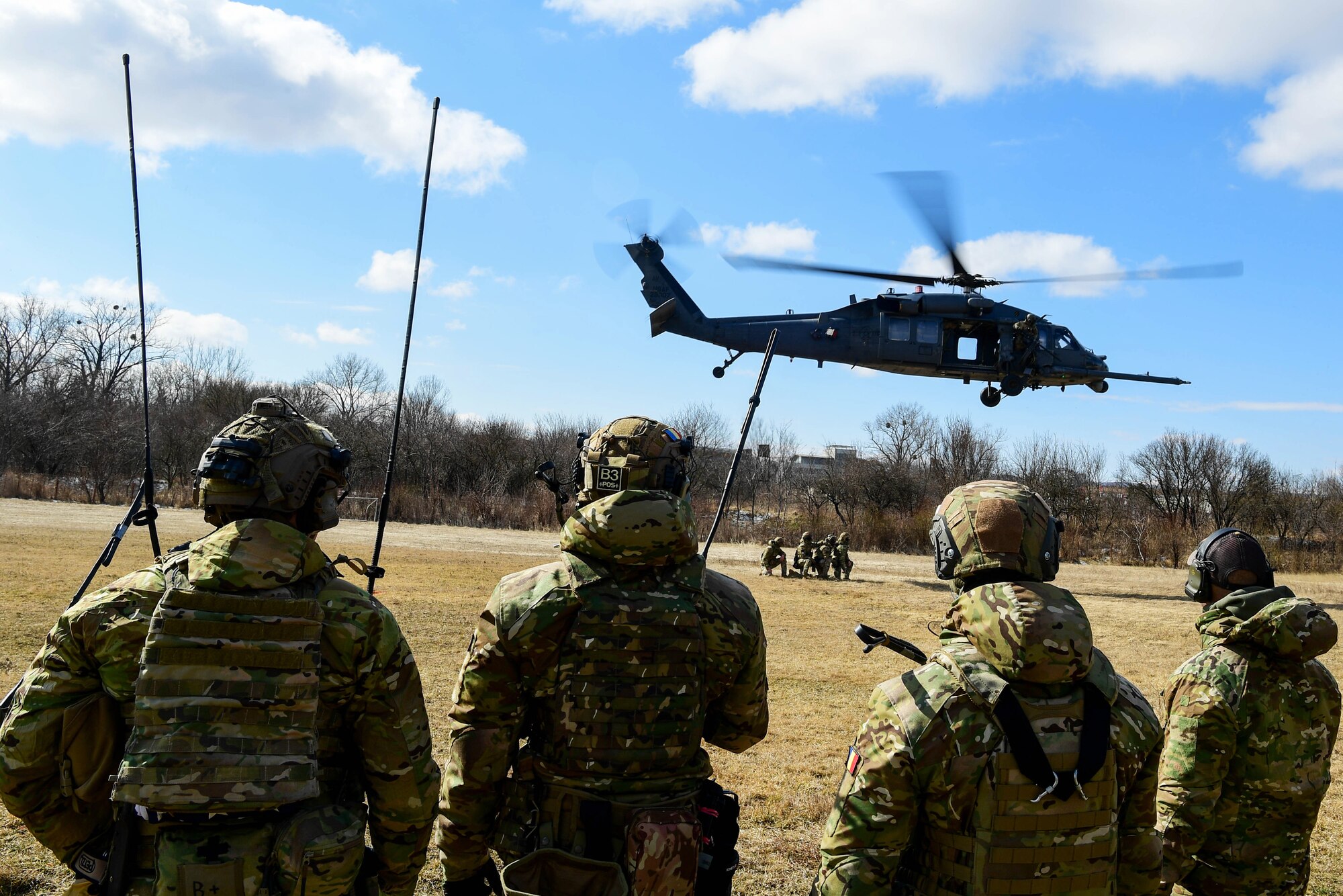 The 51st Commando Battalion Romanian Special Forces offload an HH-60G Pave Hawk assigned to the 56th Rescue Squadron in Romania, March 9, 2022. The 57th RQS and the 56th RQS alongside the Royal Marines Commando Mobile Air Operations team with Commando Helicopter Force provided various training to Romanian forces, including on and offloading a helicopter. (U.S. Air Force Photo by Senior Airman Noah Sudolcan)