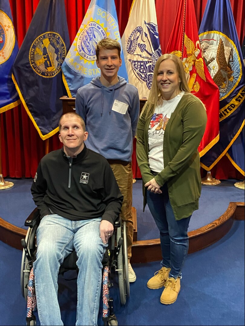 Connor Briest with his father, Sgt. Corey Briest, and mother, Jenny, as he joins the South Dakota Army National Guard at the Military Entrance Processing Station in Sioux Falls, S.D., March 11, 2022.