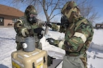 Senior Master Sgt. Jeremy Wilson, of the 128th Air Refueling Wing, and Master Sgt. Jason Braun, of the 133rd Civil Engineer Squadron, use chemical, biological, radiological and nuclear (CBRN) detection equipment during a training exercise at the North Dakota Air National Guard Regional Training Site, Fargo, North Dakota, March 9, 2022.