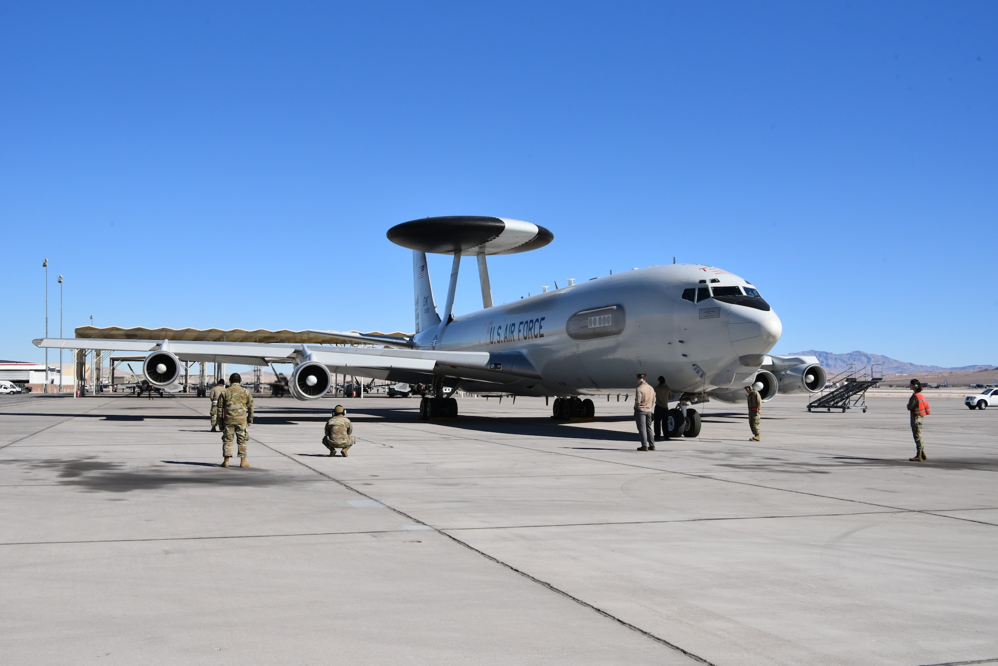 E-3A aircraft on ramp with maintenance personnel performing checks