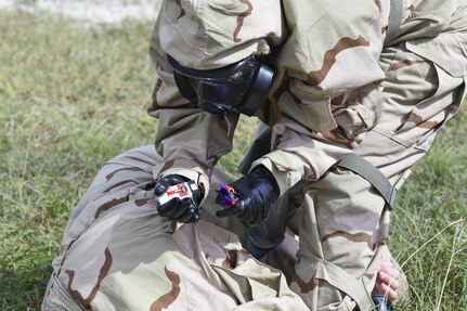 While wearing MOPP Level 4 gear a test player prepares to use a ROCS auto-injector on a simulated causality.