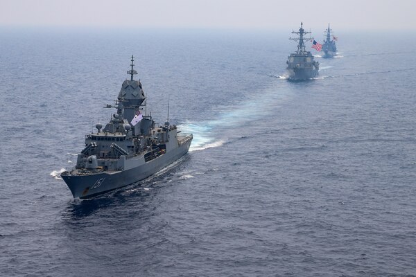 SOUTH CHINA SEA (March 15, 2022) The guided-missile destroyer USS Momsen (DDG 92), Royal Australian Navy Anzac-class frigate HMAS Arunta (FFH 151), and Japan Maritime Self-Defense Force Murasame-class guided missile destroyer JS Yuudachi (DD 103) transit the South China Sea during a trilateral training event. Momsen is assigned to Commander, Task Force 71/Destroyer Squadron (DESRON) 15, the Navy's largest forward-deployed DESRON and the U.S. 7th Fleet's principal fighting force, and is underway supporting a free and open Indo-Pacific. (U.S. Navy photo by Naval Air Crewman (Helicopter) 3rd Class Regnor Vondedenroth)