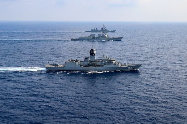 SOUTH CHINA SEA (March 15, 2022) The guided-missile destroyer USS Momsen (DDG 92), Royal Australian Navy Anzac-class frigate HMAS Arunta (FFH 151), and Japan Maritime Self-Defense Force Murasame-class guided missile destroyer JS Yuudachi (DD 103) transit the South China Sea during a trilateral training event. Momsen is assigned to Commander, Task Force 71/Destroyer Squadron (DESRON) 15, the Navy's largest forward-deployed DESRON and the U.S. 7th Fleet's principal fighting force, and is underway supporting a free and open Indo-Pacific. (U.S. Navy photo by Naval Air Crewman (Helicopter) 1st Class Justin Sherman)