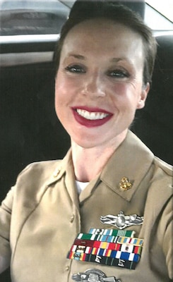 Smiling woman in her beige uniform sitting in the car