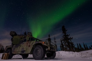 The northern lights glow above an Avenger Air Defense System assigned to 1st Battalion, 265th Air Defense Artillery Regiment, Florida Army National Guard, during Exercise ARCTIC EDGE 2022 at Eielson Air Force Base, Alaska, March 11, 2022. The Avenger air defense system is a self-propelled surface-to-air missile system which provides mobile, short-range air defense protection for ground units against cruise missiles, unmanned aerial vehicles, low-flying fixed-wing aircraft, and helicopters. (U.S. Air Force photo by Senior Airman Joseph P. LeVeille)