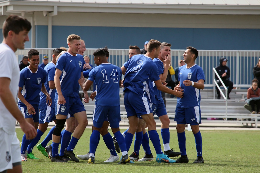 Air Force celebrates their first goal of the championship match against Navy. during the 2022 Armed Forces Men’s Soccer Championship hosted by MacDill Air Force Base in Tampa, Florida from March 6-12.  1st Lt. James Souder (second from right) of Tinker Air Force Base, Okla. scored two goals, including this one.  The best players from the Army, Marine Corps, Navy and Air Force (with Space Force players) compete for gold.  (Photo by Ms. Arianna Dinote, Department of Defense Photo - Released)