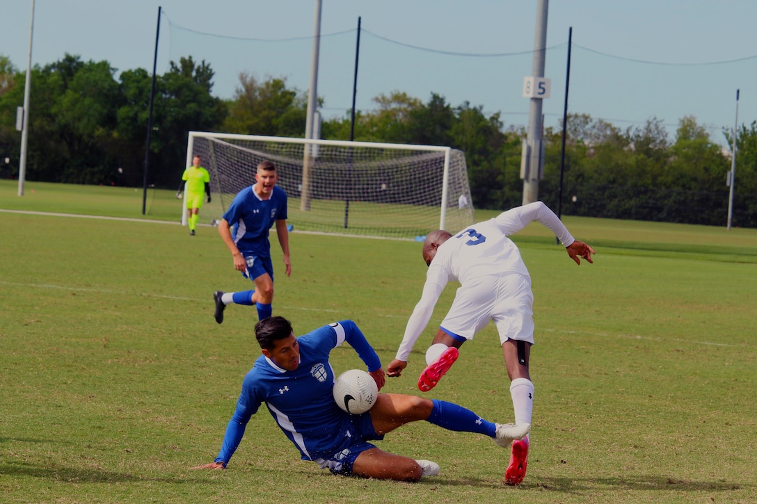 Air Force defender Capt. Aaron Zendejas of Tinker Air Forece Base, Okla. successful steals the ball from Navy Seaman Kersan Marcellin of Naval Base San Diego, Calif.  during the 2022 Armed Forces Men’s Soccer Championship hosted by MacDill Air Force Base in Tampa, Florida from March 6-12.  The best players from the Army, Marine Corps, Navy and Air Force (with Space Force players) compete for gold.  (Photo by Ms. Arianna Dinote, Department of Defense Photo - Released)