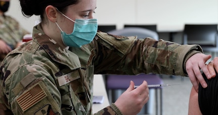 Airman gives a vaccination.