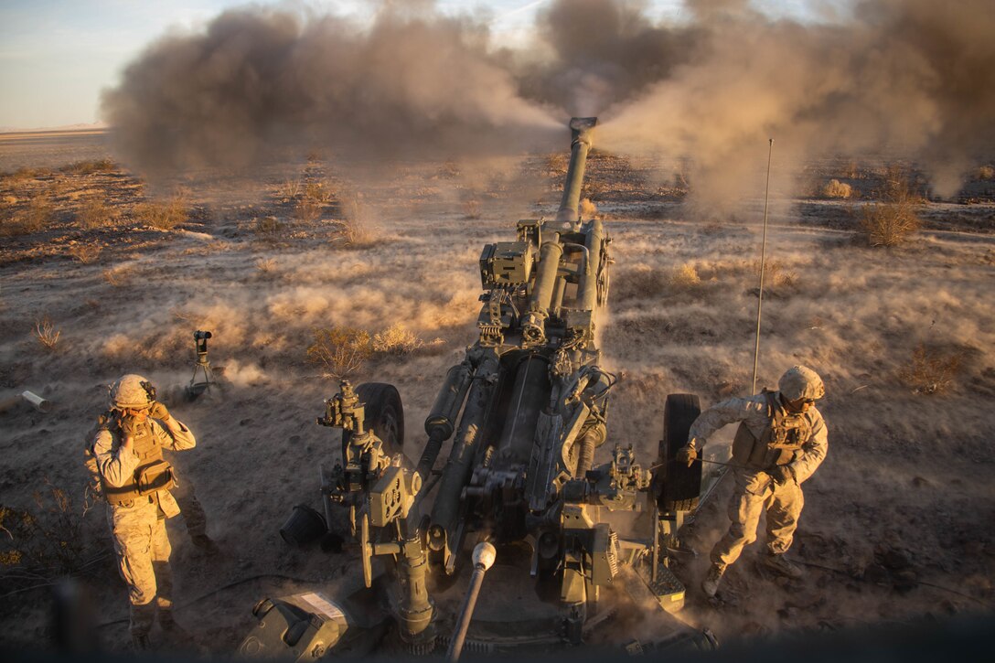 U.S. Marines with Charlie Battery, 1st Battalion, 11th Marine Regiment, 1st Marine Division, fire an M777 towed 155 mm howitzer during a fire exercise (FIREX) on Marine Corps Air-Ground Combat Center Twentynine Palms, California, Feb. 27, 2022. This regimental-level evolution provided an opportunity for multiple batteries to train together, developing small unit leadership while increasing efficiency and lethality. (U.S. Marine Corps photo by Lance Cpl. Brayden Daniel)