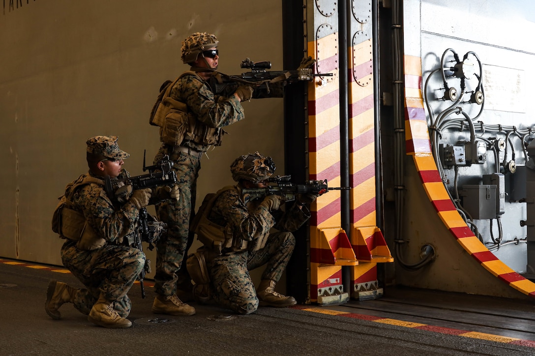U.S. Marines with Golf Co., 2d Battalion, 5th Marine Regiment (2/5), 1st Marine Division, run on-off drills aboard USS Tripoli (LHA-7), Feb. 22, 2022. The Marines of 2/5 participated in an embassy reinforcement exercise organized by Expeditionary Operations Training Group in order to ensure Marines who are preparing to deploy are ready for complex combat situations. (U.S. Marine Corps photo by Cpl. Benjamin Aulick)