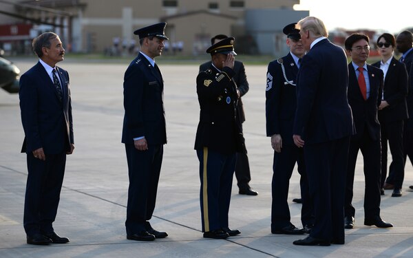 U.S. Army Command Sgt. Maj. Walter Tagalicud, Command Sergeant Major, United States Forces Korea, salutes President Donald J. Trump on the flightline at Osan Air Base, Republic of Korea, June 29, 2019.